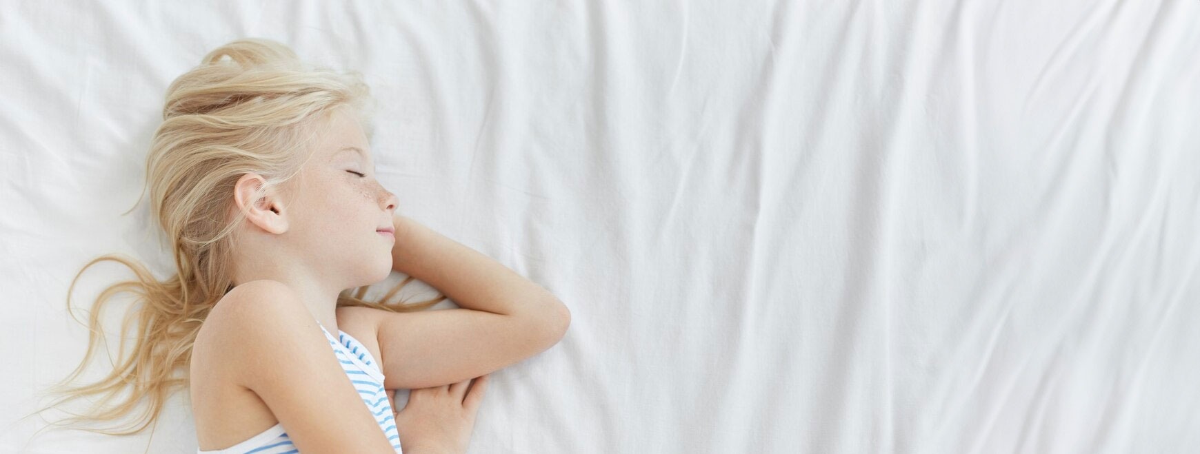 Child sleeping comfortably in a clean bedroom